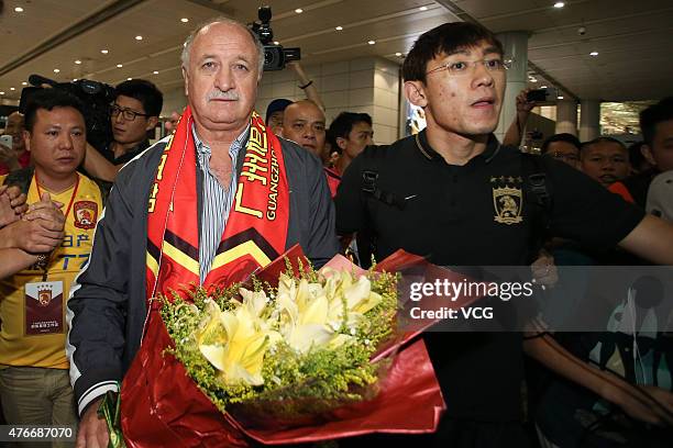 Football fans welcome Luiz Felipe Scolari, new coach of Guangzhou Evergrande, on his arrival at Baiyun International Airport on June 11, 2015 in...