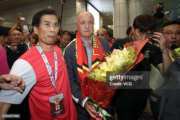 Football fans welcome Luiz Felipe Scolari, new coach of Guangzhou Evergrande, on his arrival at Baiyun International Airport on June 11, 2015 in...