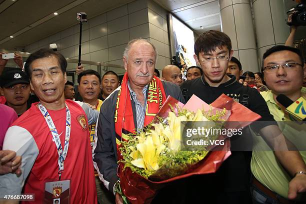 Football fans welcome Luiz Felipe Scolari, new coach of Guangzhou Evergrande, on his arrival at Baiyun International Airport on June 11, 2015 in...