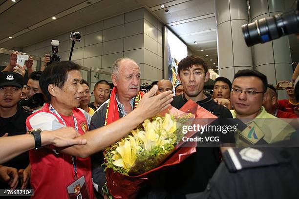 Football fans welcome Luiz Felipe Scolari, new coach of Guangzhou Evergrande, on his arrival at Baiyun International Airport on June 11, 2015 in...