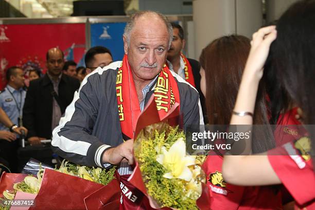 Football fans welcome Luiz Felipe Scolari, new coach of Guangzhou Evergrande, on his arrival at Baiyun International Airport on June 11, 2015 in...