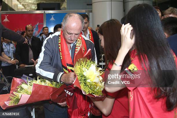 Football fans welcome Luiz Felipe Scolari, new coach of Guangzhou Evergrande, on his arrival at Baiyun International Airport on June 11, 2015 in...
