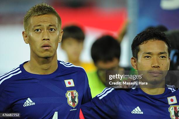 Keisuke Honda and Yuto Nagatomo of Japan look on prior to the international friendly match between Japan and Iraq at Nissan Stadium on June 11, 2015...