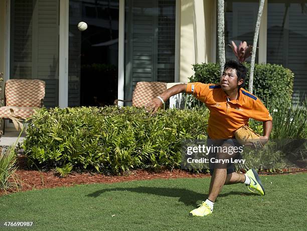 Hideki Matsuyama pitches a baseball after practice for the World Golf Championships-Cadillac Championship at Blue Monster, Trump National Doral, on...