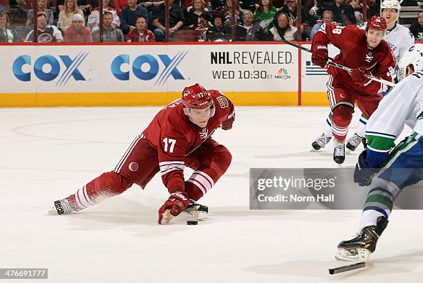 Radim Vrbata of the Phoenix Coyotes uses his glove to stop the puck after breaking his stick against the Vancouver Canucks during the second period...