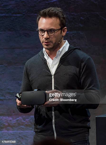 Brendan Iribe, co-founder and chief executive officer of Oculus VR Inc., displays the new Oculus Rift virtual reality headset while speaking during...