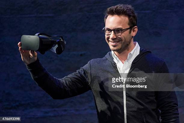 Brendan Iribe, co-founder and chief executive officer of Oculus VR Inc., displays the new Oculus Rift virtual reality headset while speaking during...