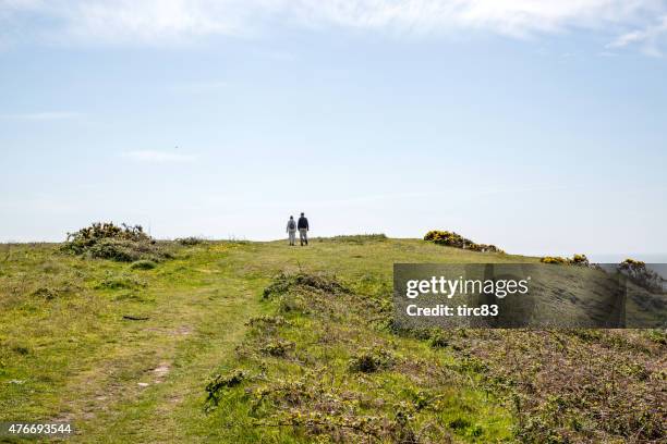 walkers on gower coastal path - gower peninsula stock pictures, royalty-free photos & images