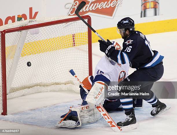 Andrew Ladd of the Winnipeg Jets scores a goal against Anders Nilsson of the New York Islanders in third period action in an NHL game at the MTS...