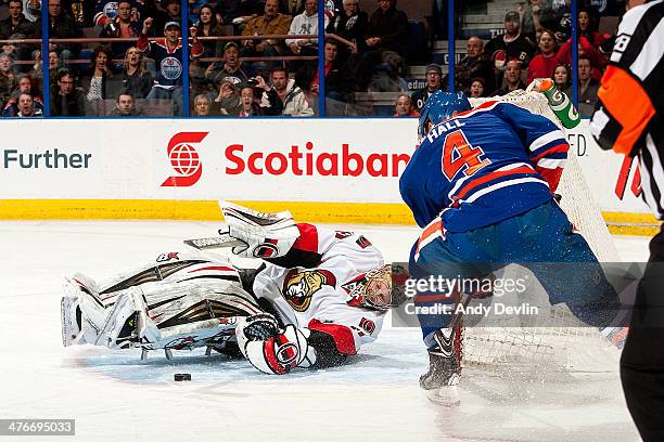Taylor Hall of the Edmonton Oilers has his shot stopped by goalie Craig Anderson of the Ottawa Senators on March 4, 2014 at Rexall Place in Edmonton,...