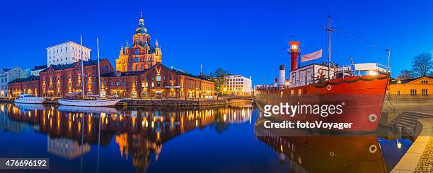 helsinki uspenski cathedral overlooking tranquil waterfront harbour illuminated dusk finland - helsinki finland stock pictures, royalty-free photos & images