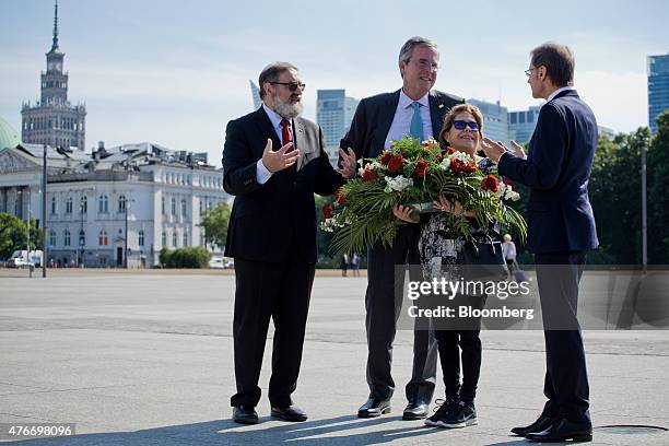 Jeb Bush, former governor of Florida, second left, lays a wreath with his wife Columba Bush, second right, and members of Polish American Freedom...