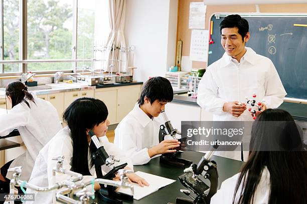 japanese high school. students study, science laboratory, microscopes on benches - lab bench stock pictures, royalty-free photos & images