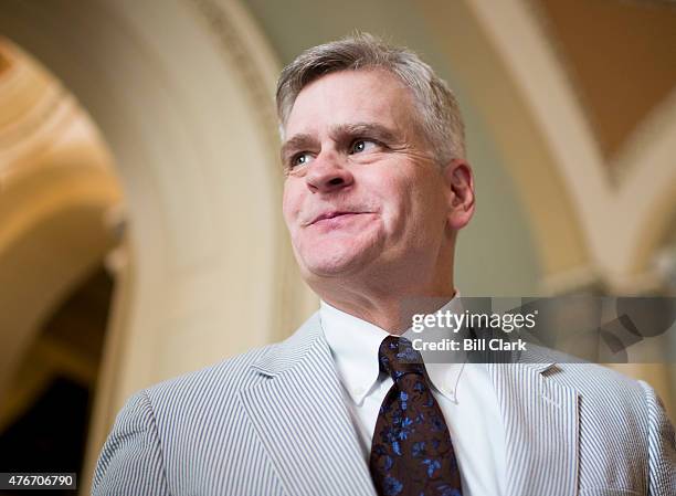 Sen. Bill Cassidy, R-La., speaks with reporters in the Ohio Clock Corridor after posing with other Senators for the Official National Seersucker Day...