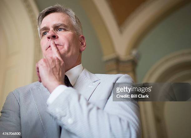 Sen. Bill Cassidy, R-La., speaks with reporters in the Ohio Clock Corridor after posing with other Senators for the Official National Seersucker Day...