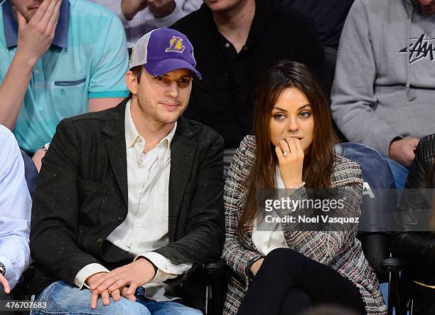 Ashton Kutcher and Mila Kunis attend basketball games between the New Orleans Pelicans and the Los Angeles Lakers at Staples Center on March 4, 2014...