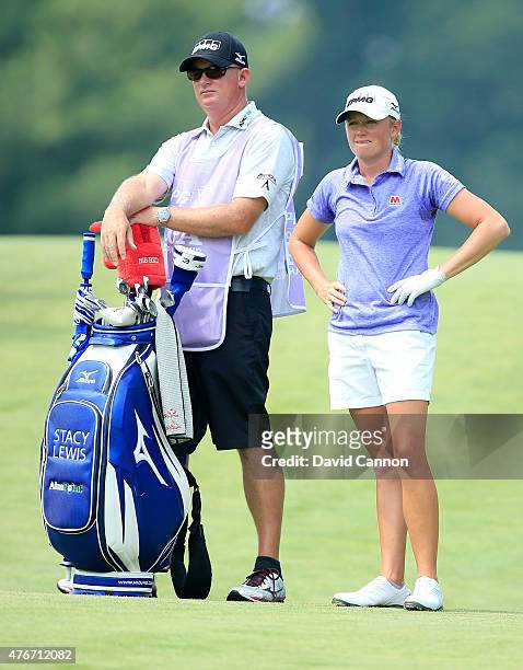 Stacy Lewis of the United States waits to play her second shot on the par 5, 12th hole with her caddie Travis Wilson during the first round of the...