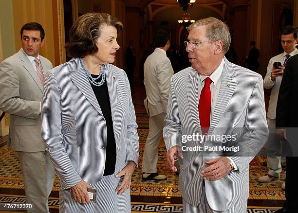 Sen. Dianne Feinstein talks with Sen. Johnny Isakson before a group photo to celebrate National Seersucker Day at the U.S. Capitol Building on June...