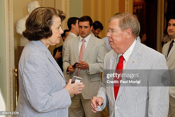 Sen. Dianne Feinstein talks with Sen. Johnny Isakson before a group photo to celebrate National Seersucker Day at the U.S. Capitol Building on June...