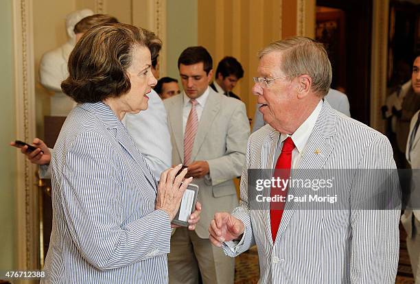 Sen. Dianne Feinstein talks with Sen. Johnny Isakson before a group photo to celebrate National Seersucker Day at the U.S. Capitol Building on June...