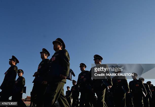 Military delegates arrive for the first session of the National People's Congress at the Great Hall of the People in Beijing on March 5, 2014....