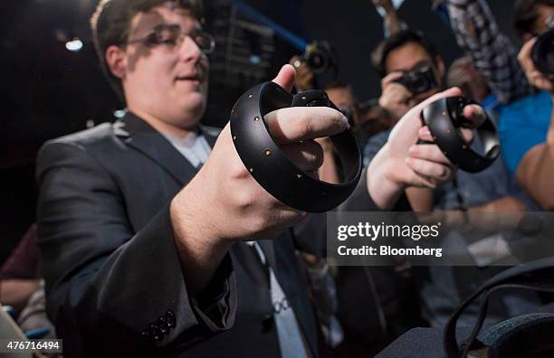 Palmer Luckey, co-founder of Oculus VR Inc. And creator of the Oculus Rift, demonstrates the new Oculus Touch controller during the "Step Into The...