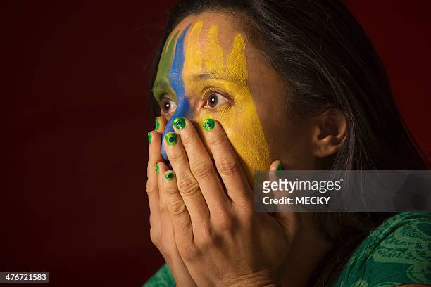 sports fan watching brazilian team - female football fans stock pictures, royalty-free photos & images