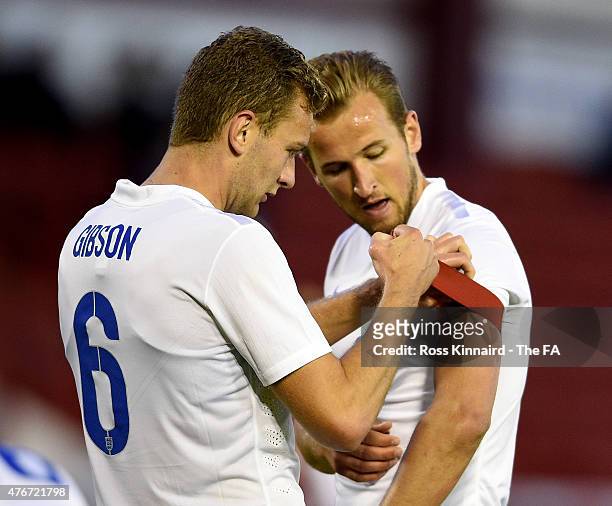 Ben Gibson of England helps Harry Kane of England with the captains arm-band during the international friendly match between England U21 and Belarus...