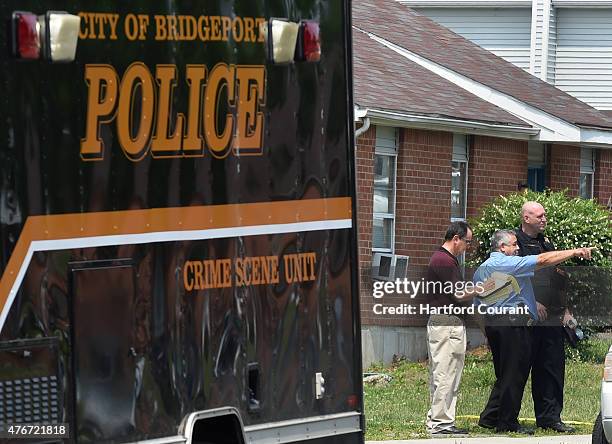 Bridgeport police and detectives investigate at the scene of a shooting at Trumbull Gardens in Bridgeport, Conn., on Thursday, June 12, 2015.