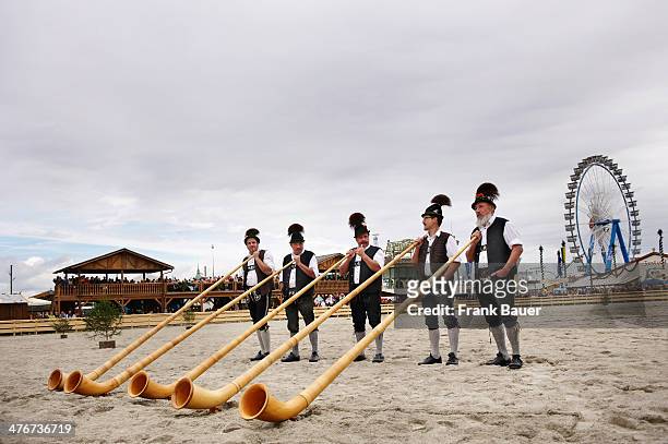 Musicians wearing traditional Bavarian attire with Alpenhorn at the Oktoberfest on September 17, 2010 in Munich, Germany.