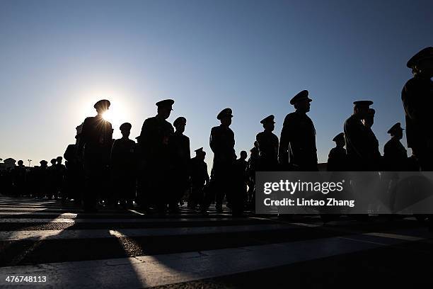 Delegates from Chinese People's Liberation Army march walks from Tiananmen Square to the Great Hall of the People to attend the opening ceremony of...