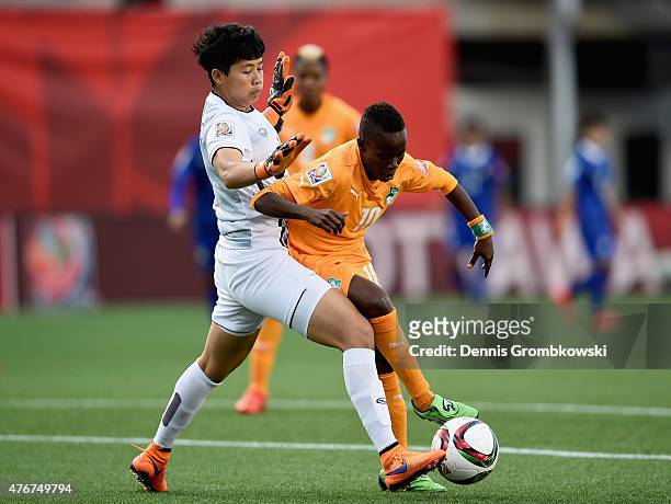 Waraporn Boonsing of Thailand and Ange Nguessen of Cote D'Ivoire battle for the ball during the FIFA Women's World Cup Canada 2015 Group B match...