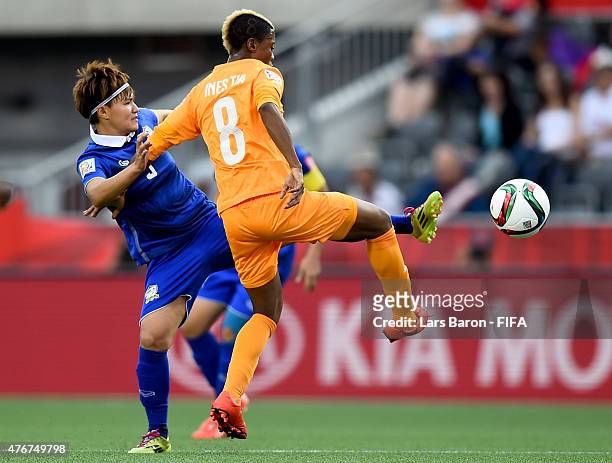 Natthakarn Chinwong of Thailand challenges Ines Nrehy of Cote D'Ivoire during the FIFA Women's World Cup 2015 Group B match between Cote d'Ivoire and...