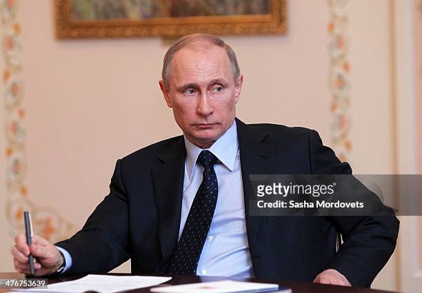 Russian President Vladimir Putin speaks during a meeting with ministers from The Summit of Eurasian Economic Cooperation Council at Novo Ogaryovo...