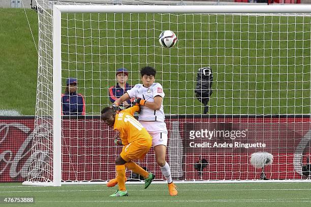 Waraporn Boonsing of Thailand battles for the ball against Ange N'Guessan of Cote d'Ivoire during the FIFA Women's World Cup Canada 2015 Group B...