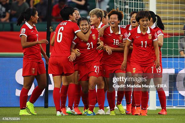 Wang Lisi of China PR is swarmed by teammates after scoring the game winning goal against the Netherlands during the FIFA Women's World Cup Canada...