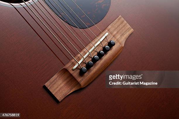 Detail of the Morado wood bridge and bone saddle on a Martin D-17M acoustic guitar, taken on May 20, 2013.