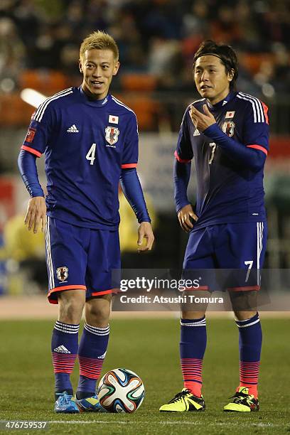 Keisuke Honda and Yasuhito Endo of Japan talk during the Kirin Challenge Cup international friendly match between Japan and New Zealand at National...