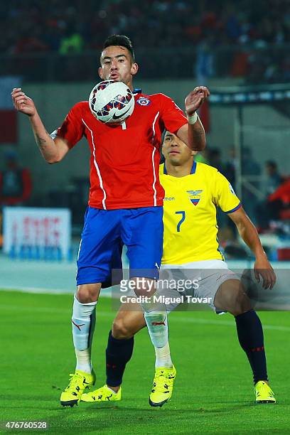 Mauricio Isla of Chile controls the ball as Jefferson Montero of Ecuador tries to stop him during the 2015 Copa America Chile Group A match between...