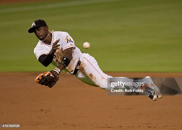 Adeiny Hechavarria of the Miami Marlins throws to first base during the third inning of the game against the Colorado Rockies at Marlins Park on June...