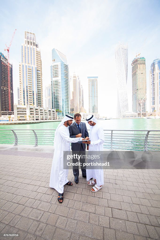 Businessmen standing in front of city skyline
