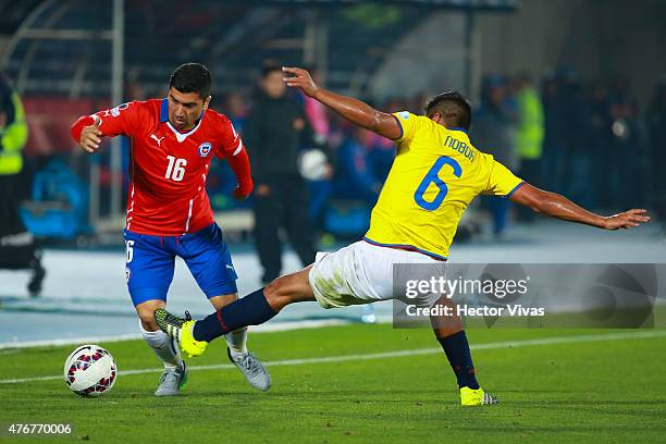 David Pizarro of Chile fights for the ball with Christian Noboa of Ecuador during the 2015 Copa America Chile Group A match between Chile and Ecuador...