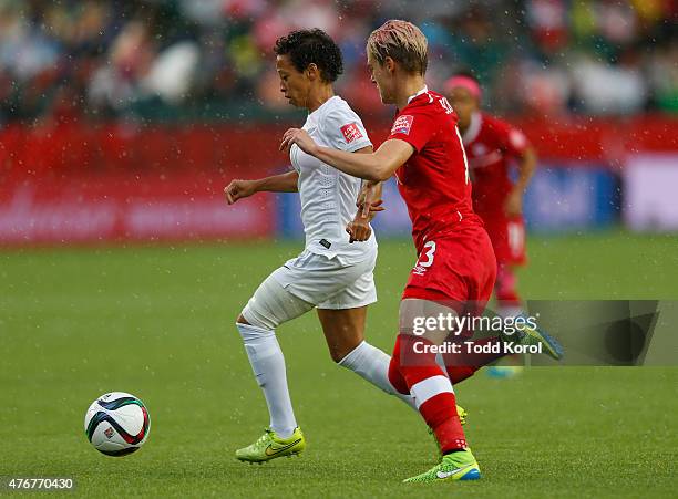 Sophie Schmidt of Canada chases Sarah Gregorius of New Zealand for the ball during the FIFA Women's World Cup Canada Group A match between China and...