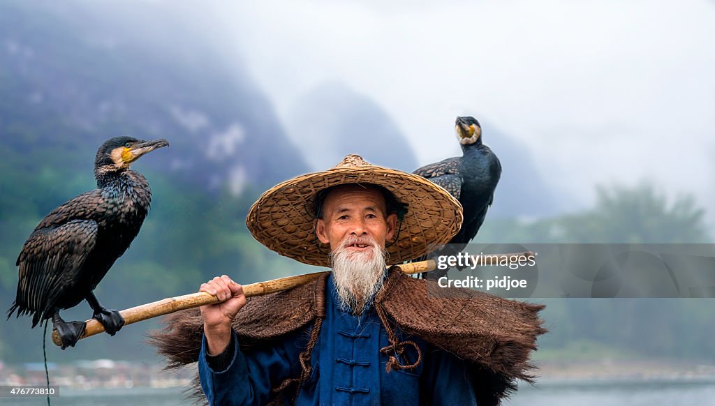 Portrait Chinese traditional fisherman with cormorants fishing, Li River China