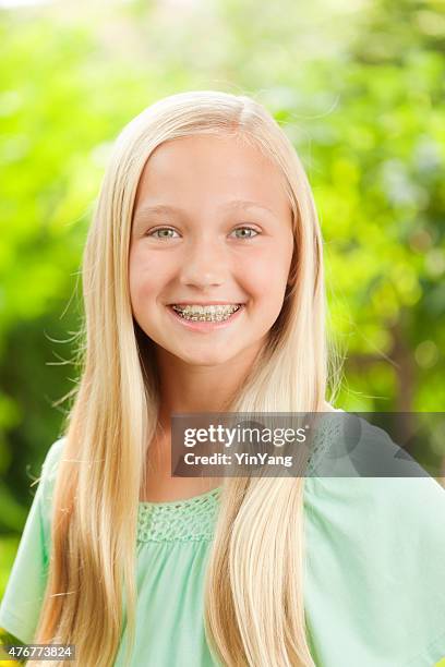 young caucasian teen girl portrait with dental teeth braces - 12 year old blonde girl stock pictures, royalty-free photos & images