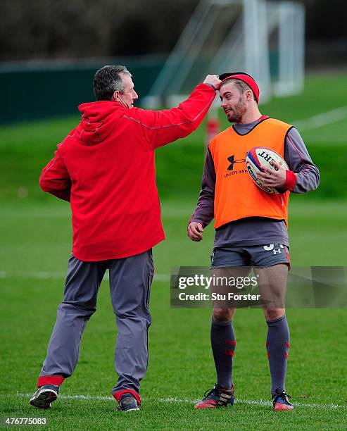 Wales coach Robert Howley playfully takes the wooly hat off Leigh Halfpenny's head during Wales training, ahead of their RBS six nations match...