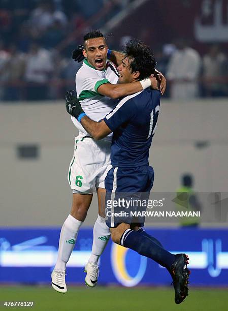 Ali Adnan Kadhim al-Tameemi of Iraq celebrates with goalkeeper Jalal Hassan Hachim after winning against China their qualification football match for...