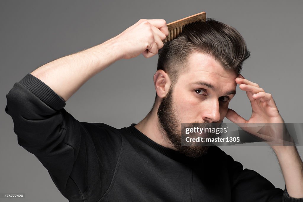 Young man comb his hair
