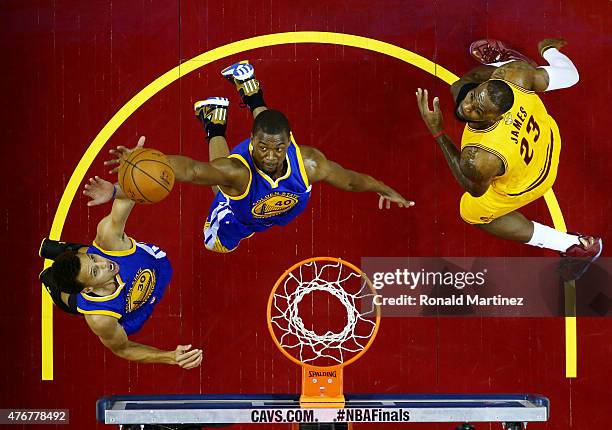 Harrison Barnes of the Golden State Warriors goes up against LeBron James of the Cleveland Cavaliers in the first half during Game Four of the 2015...