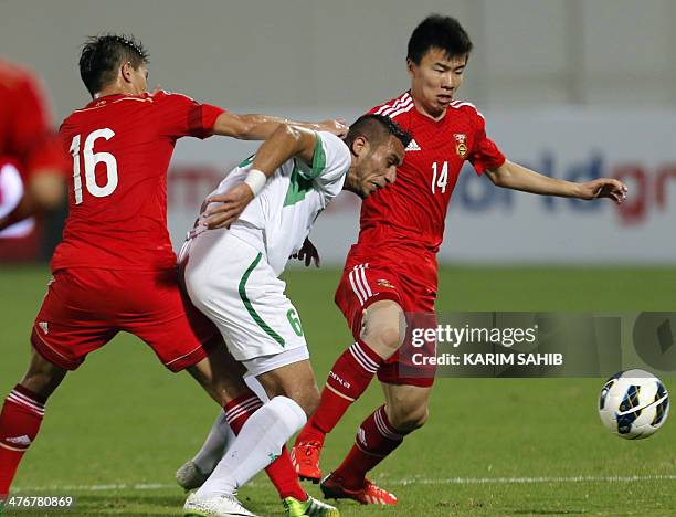 Iraq's Ali Adnan fights for the ball with Sun Ke of China during their qualification football match for the Asian Cup Australia 2015, China versus...